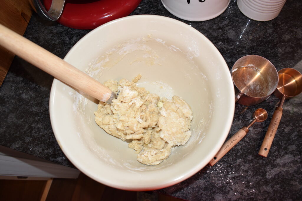 Dough being mixed with a dough whisk