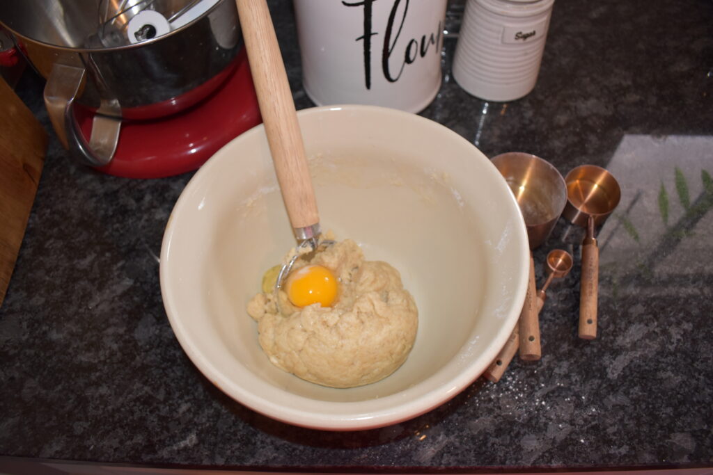 Raw egg on top of mixed dough