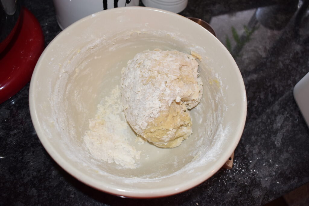 Kneading dough in the bowl to incorporate all the flour