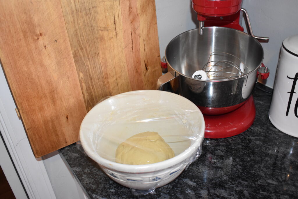 mixing bowl on counter with plastic wrap over the top