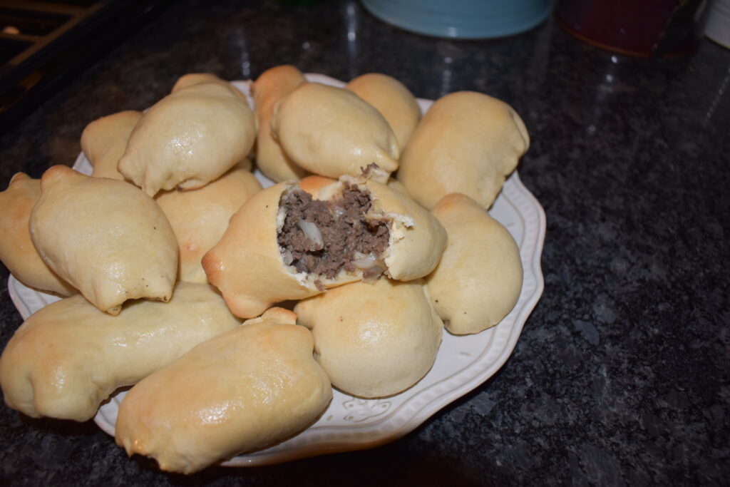 Deer Runzas on a plate with one open to show the filling