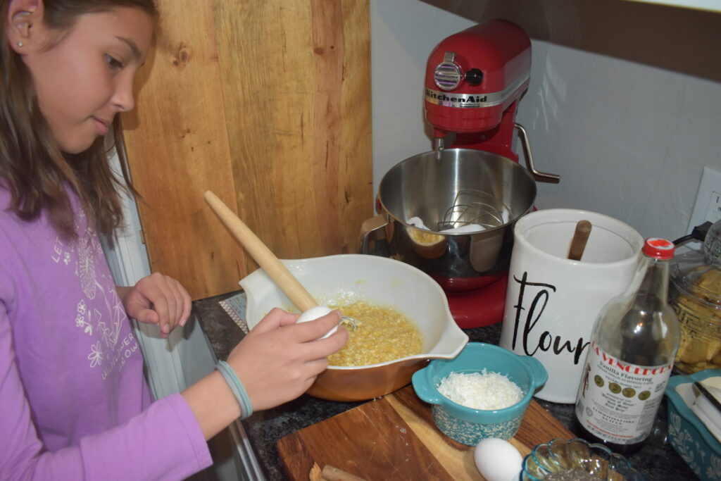 Child cracking an egg in a bowl