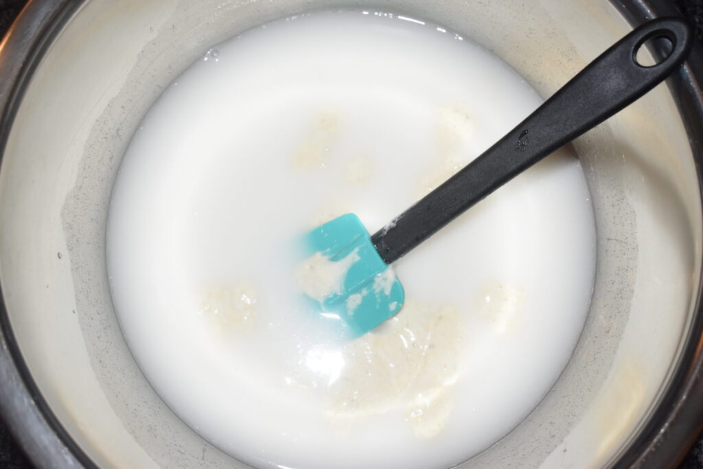 Water and starter mixing in a mixing bowl