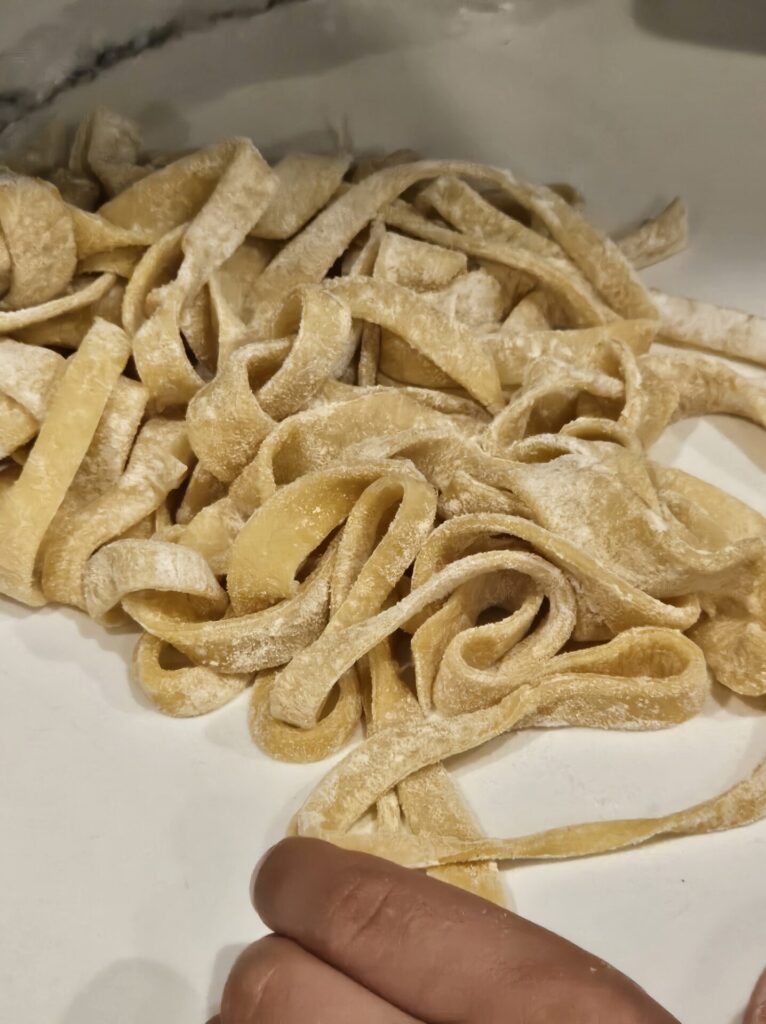 Close up shot of pasta strips with a dusting of flour