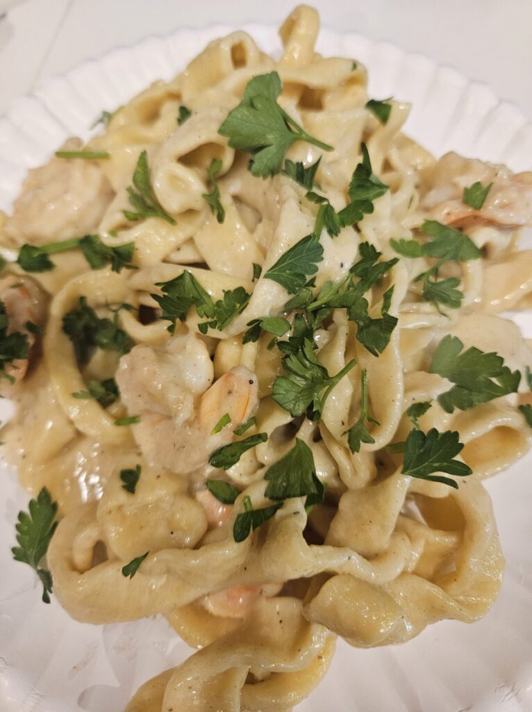 close up of the finished dish of shrimp and pasta with a creamy sauce