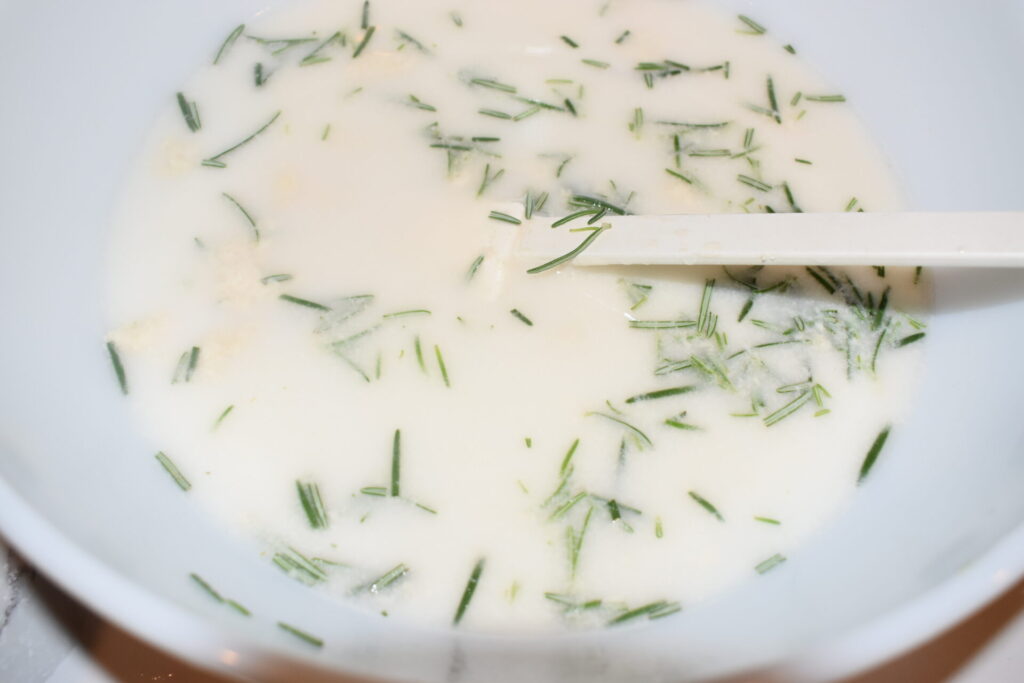 Rosemary mixed in a bowl with water and sourdough starter