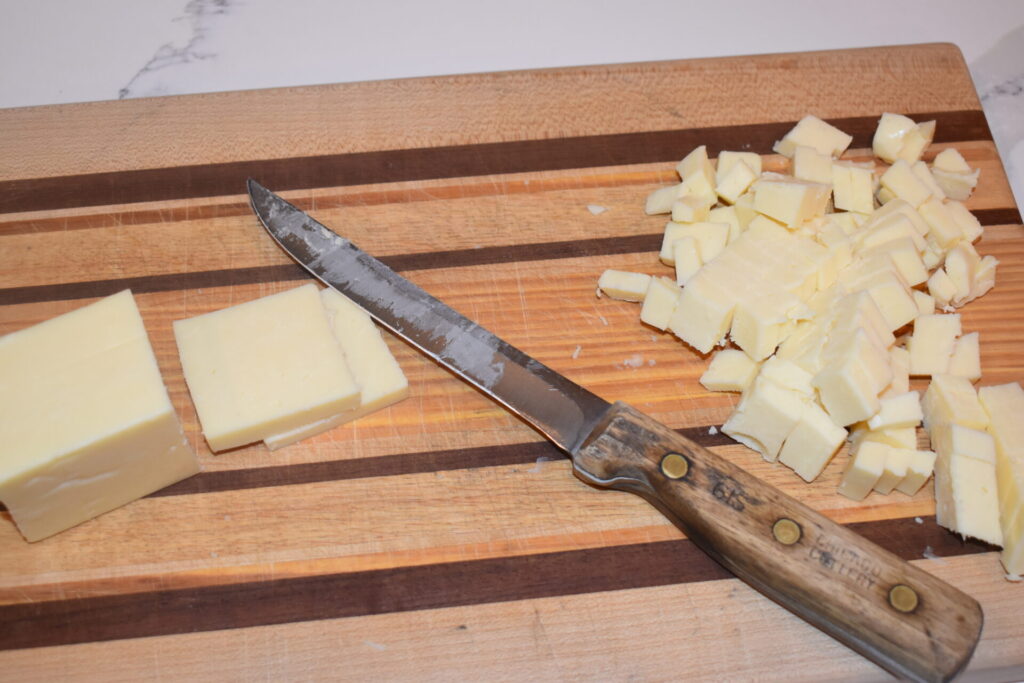 Cheese cut up on a cutting board