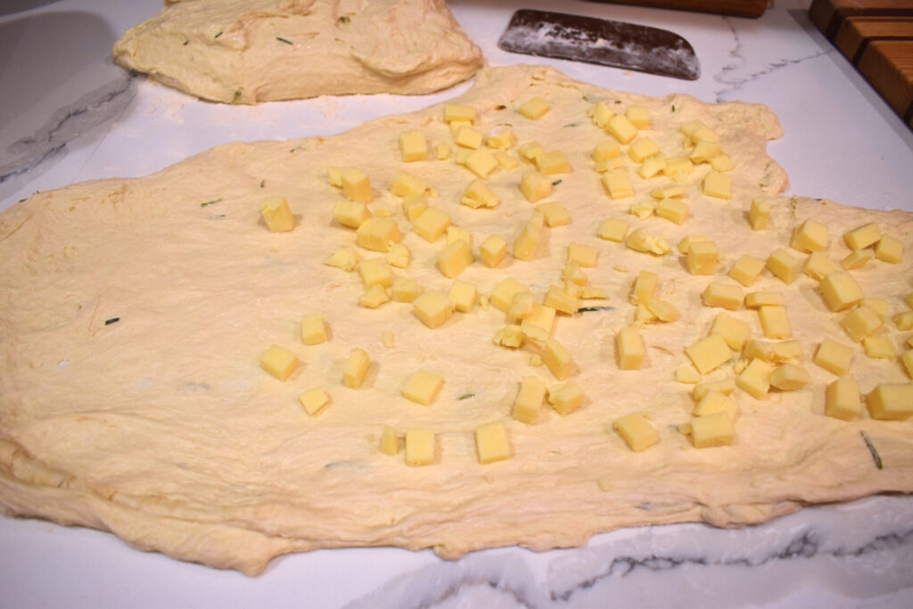 Sourdough with cheese spread out on a counter